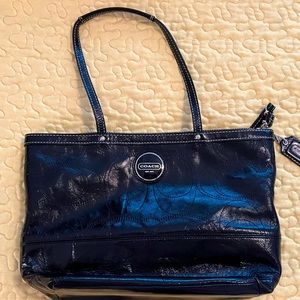 Coach black patent leather. Good condition. Minor ink marks inside at the top.